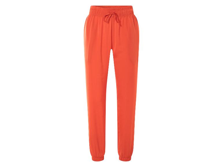 Oranje joggingbroek met trekkoord.
