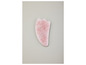 Een roze kwarts gua sha-steen voor gezichtsmassage.