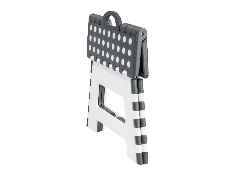 Een opvouwbare kruk met stippenpatroon.