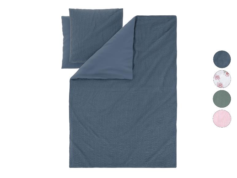 Blauw omkeerbaar dekbedovertrekset met kussens en kleurstalen.