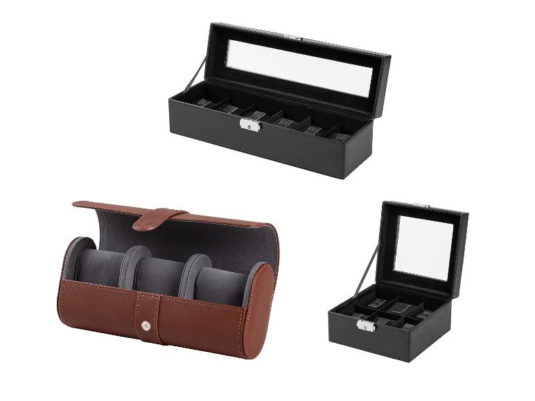 Drie horlogedozen: twee zwarte, één bruine, met vakken en transparante deksels.