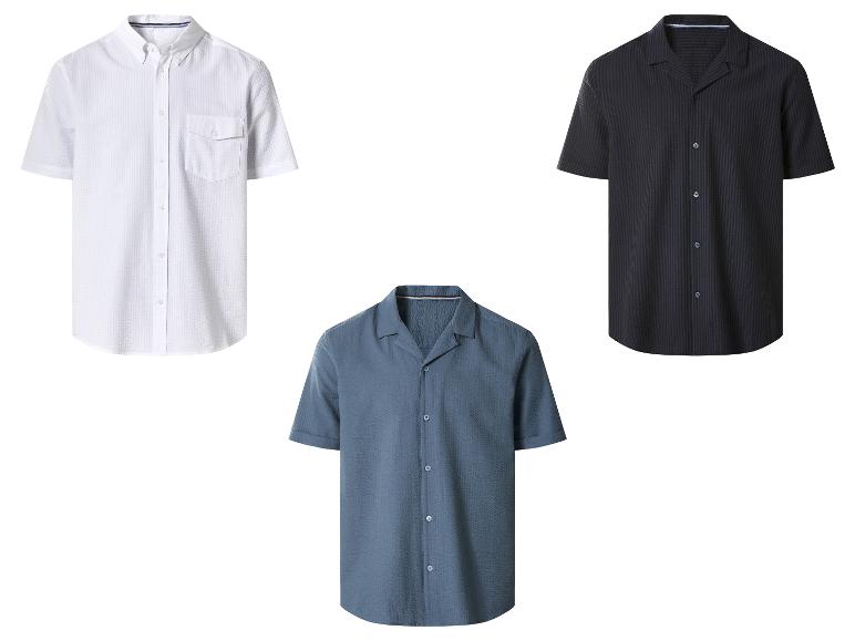 Drie herenoverhemden met korte mouwen: wit, blauw en zwart.