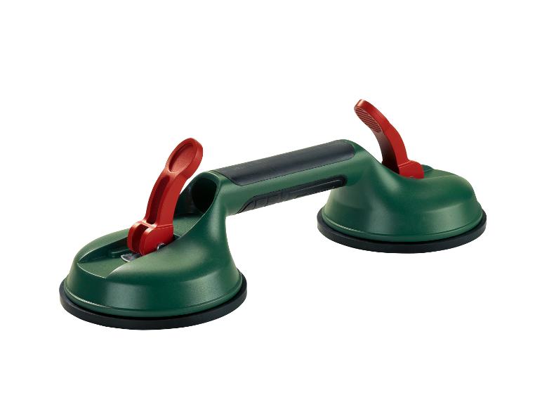 Groene zuignap met twee rode hendels voor het hanteren van tegels of glas.