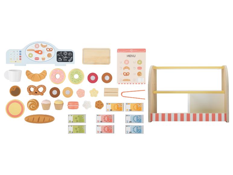 Een speelgoedbakkerijset met kassa, etenswaren, menu en geld.