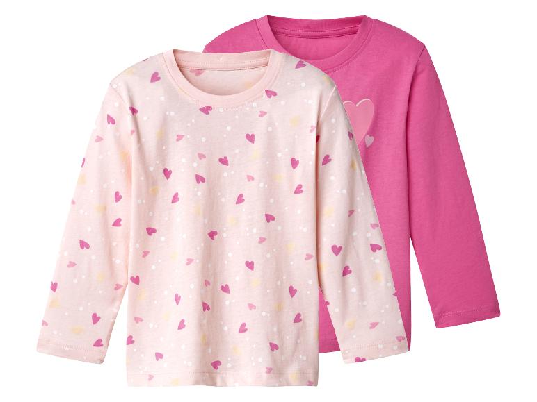 Twee kinder shirts met lange mouwen, één roze met hartjes en één effen fuchsia.
