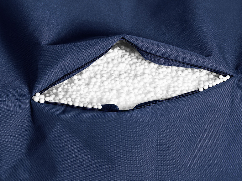 Blauwe stoffen hoes met open rits, gevuld met witte polystyreenkorrels.