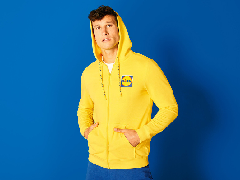 Een man draagt een gele hoodie met een Lidl-logo.