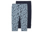 Twee leggings voor meisjes, één met schelpenprint en één effen donkerblauw.