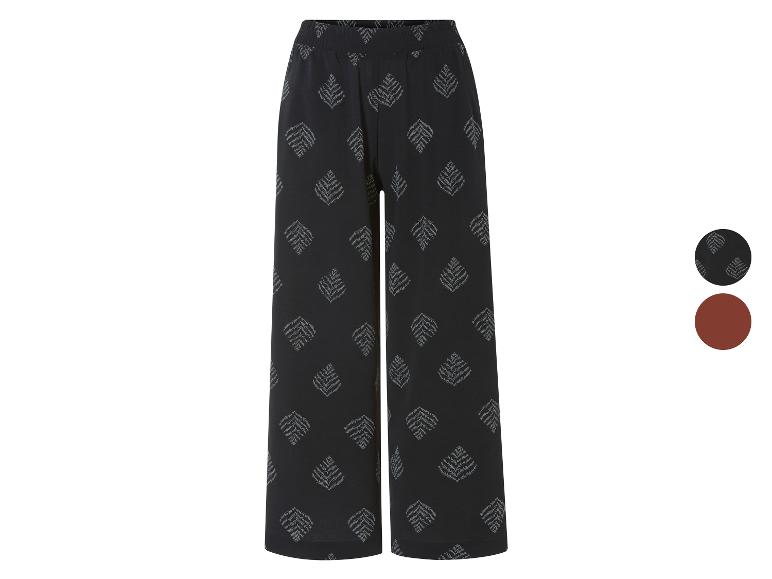 Wijde broek met bladmotief, in zwart en bruin.