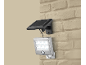 LED-zonnelamp met bewegingssensor, gemonteerd op een beige bakstenen muur.