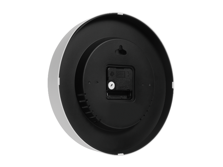 Achterkant van een ronde, wit-zwarte wandklok.