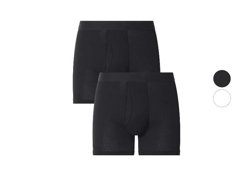 Set van twee zwarte herenboxershorts, met een zwarte en een witte cirkel rechts.