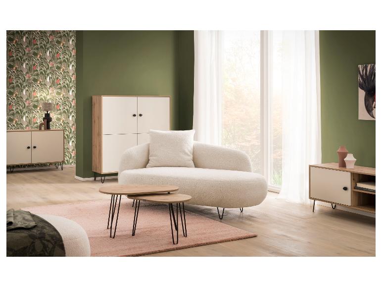 Woonkamer met crèmekleurige bank, houten salontafel en opbergkasten.