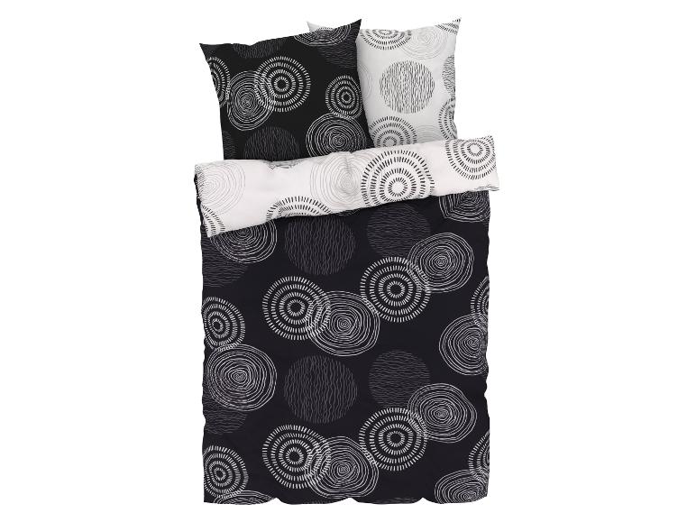 Een zwarte dekbedovertrek met witte cirkels.