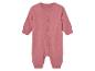 Roze baby romper met drukknoopjes.