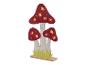 Vilt lampen in de vorm van paddenstoelen met uitgesneden bladeren.