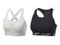 Twee Crivit sportbeha's: een witte met rits en een zwarte.