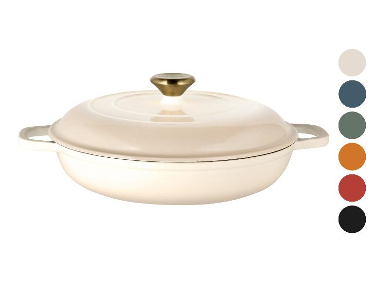 Crèmekleurige gietijzeren braadpan met gouden knop, getoond met kleurstalen.