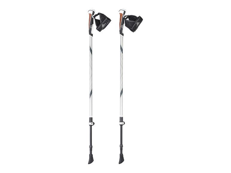 Een paar witte en zwarte wandelstokken met bruine kurken handvatten en zwarte banden.