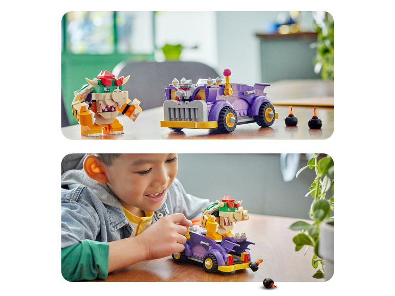 Een kind speelt met een LEGO Super Mario Bowser's  Vuurwagen set.