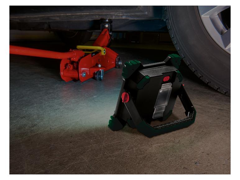 LED-werklamp verlicht een opgekrikte auto en een hydraulische krik.