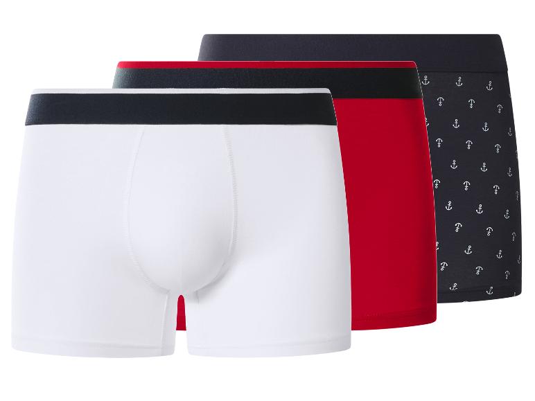 Drie herenboxershorts: wit, rood en marineblauw met ankerpatroon.