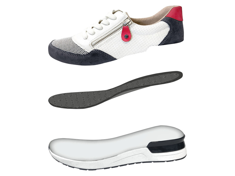 Witte sneakers met een zwarte zool en rode accenten.