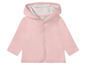 Een roze babytrui met capuchon.