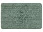 Een groene badmat met een geribbeld oppervlak.