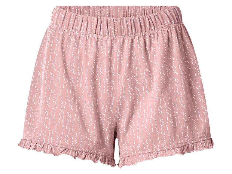 Roze pyjamashort met wit stippenpatroon en rucheszoom.
