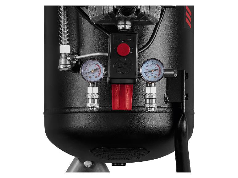 Detail van een zwarte luchtcompressor met manometers en drukregelaars.