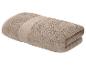Opgevouwen beige badhanddoek met een decoratieve band