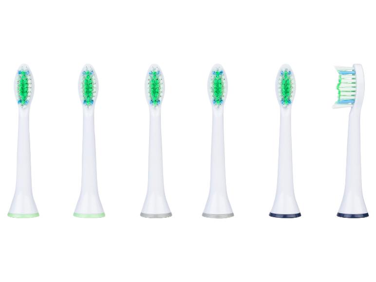 Zes witte vervangende tandenborstelkoppen met groene en blauwe borstelharen