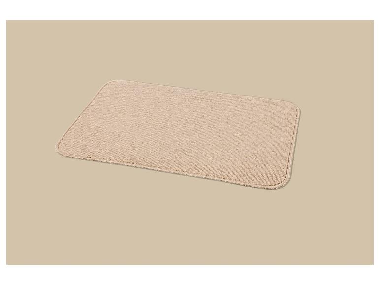 Beige rechthoekige badmat met een handdoekachtige textuur.