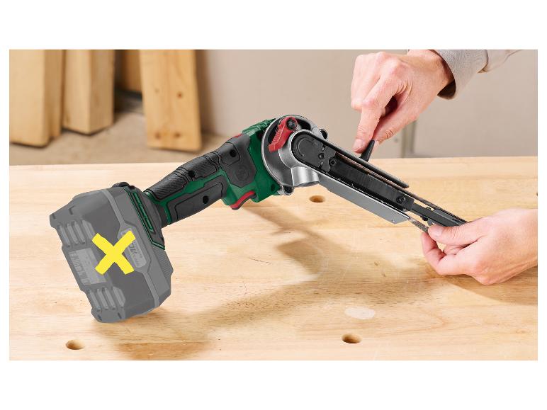 Parkside snoerloze bandschuurmachine met accu, bediend op een houten werkbank.