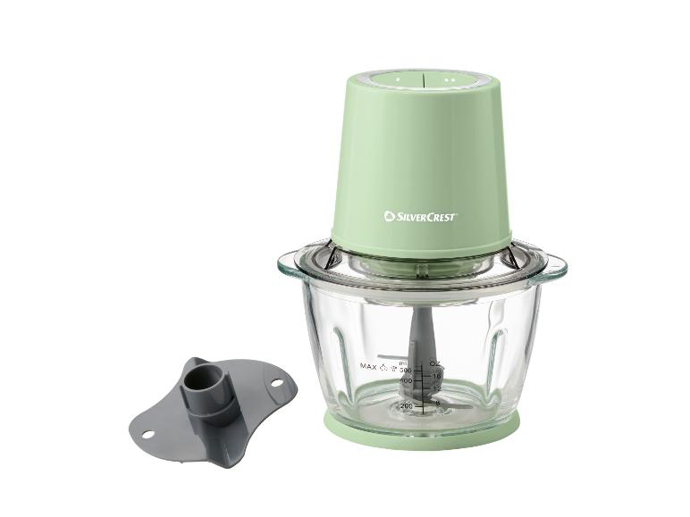 Groene hakmolen met glazen kom en accessoires, met ml- en oz-aanduidingen.