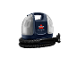 Compacte vlekkenreiniger met slang en mondstuk, transparante tanks en donkerblauwe behuizing.