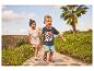 Twee kinderen lopen op een pad, het meisje draagt een top met prinsessenprint, de jongen een T-shirt met superheldenprint.