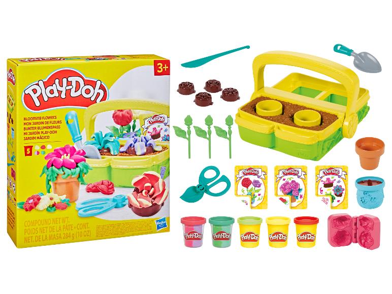 Play-Doh Blooming Flowers speelset met boetseerklei, tuingereedschap en bloemvormpjes.