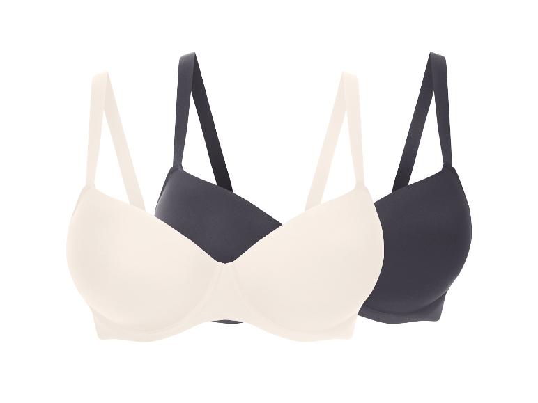 Twee beha's, één beige en één donkergrijs, op een witte achtergrond.