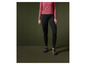 Zwarte leggings en roze sportschoenen.