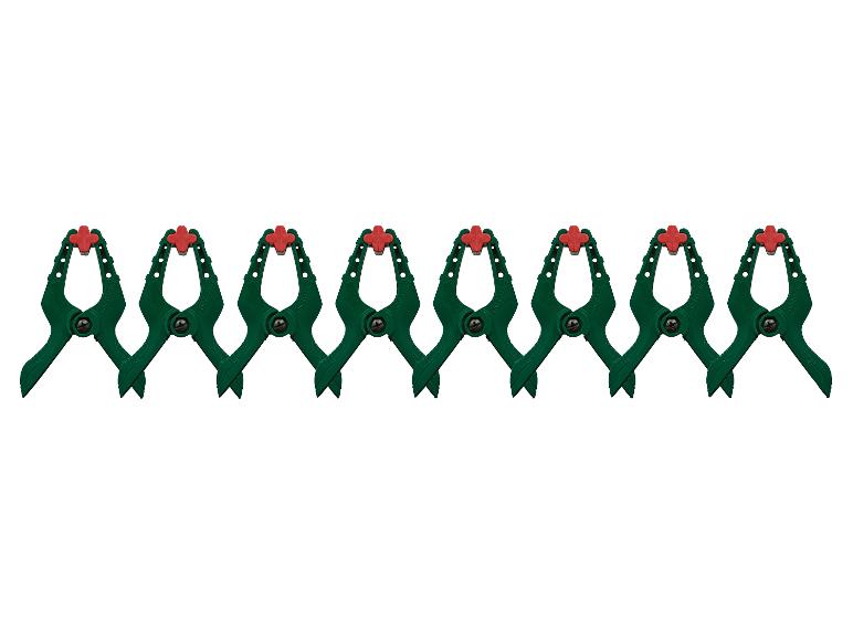 Acht groene veerklemmen met rode uiteinden, horizontaal gerangschikt in een rij.