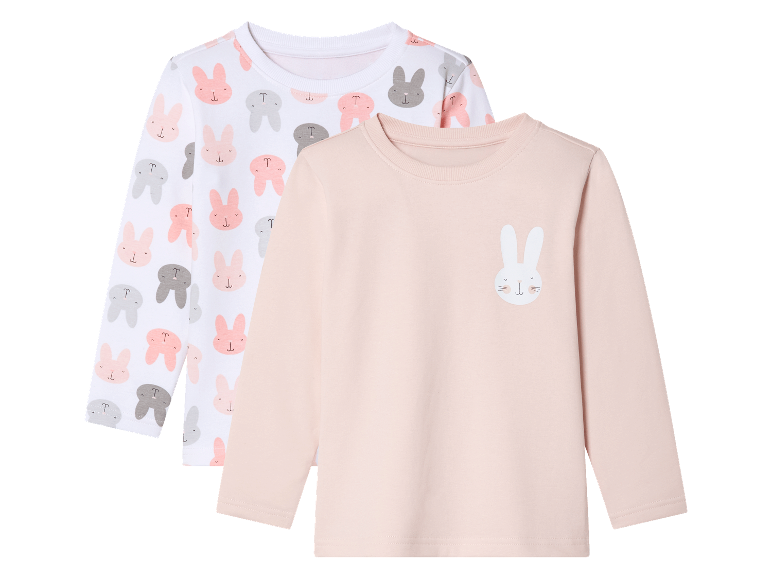 Twee baby-longsleeves, één met een konijnenprint en één lichtroze met een konijn.
