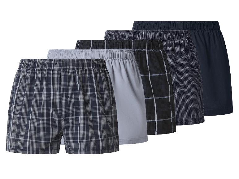 Vijf herenboxershorts in diverse patronen: geruit, geblokt en effen kleuren.