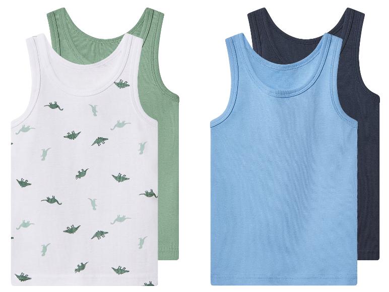 4-pack kinderonderhemden: twee witte met dinoprint en twee effen in blauw en donkerblauw.