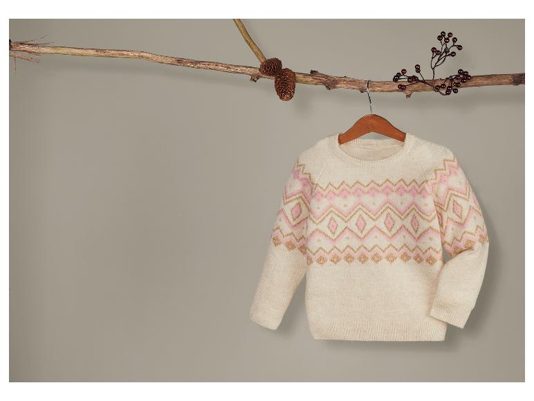 Een witte trui met een roze en gouden kerstpatroon.
