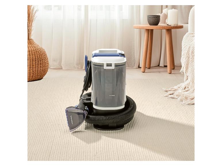 Tapijt- en meubelreiniger in een woonkamer met neutrale inrichting.