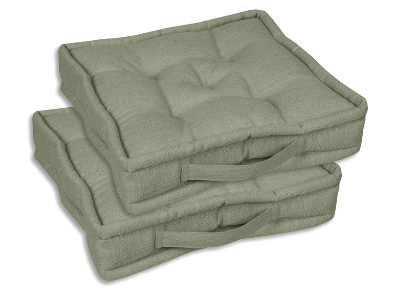 Twee groene kussens met handvatten voor op de bank.