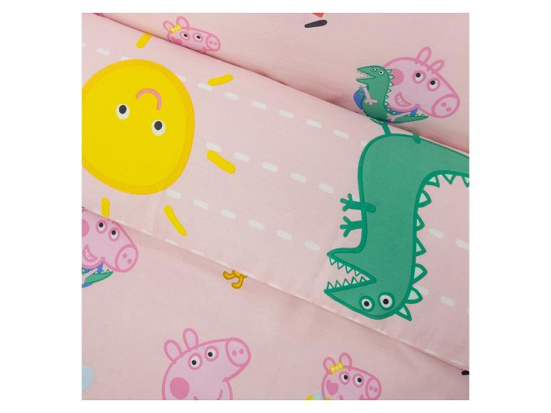 Roze beddengoed met varkens, dinosaurussen en zonprints.