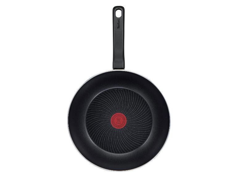 Zwarte koekenpan met handvat en een rode temperatuurindicator in het midden.